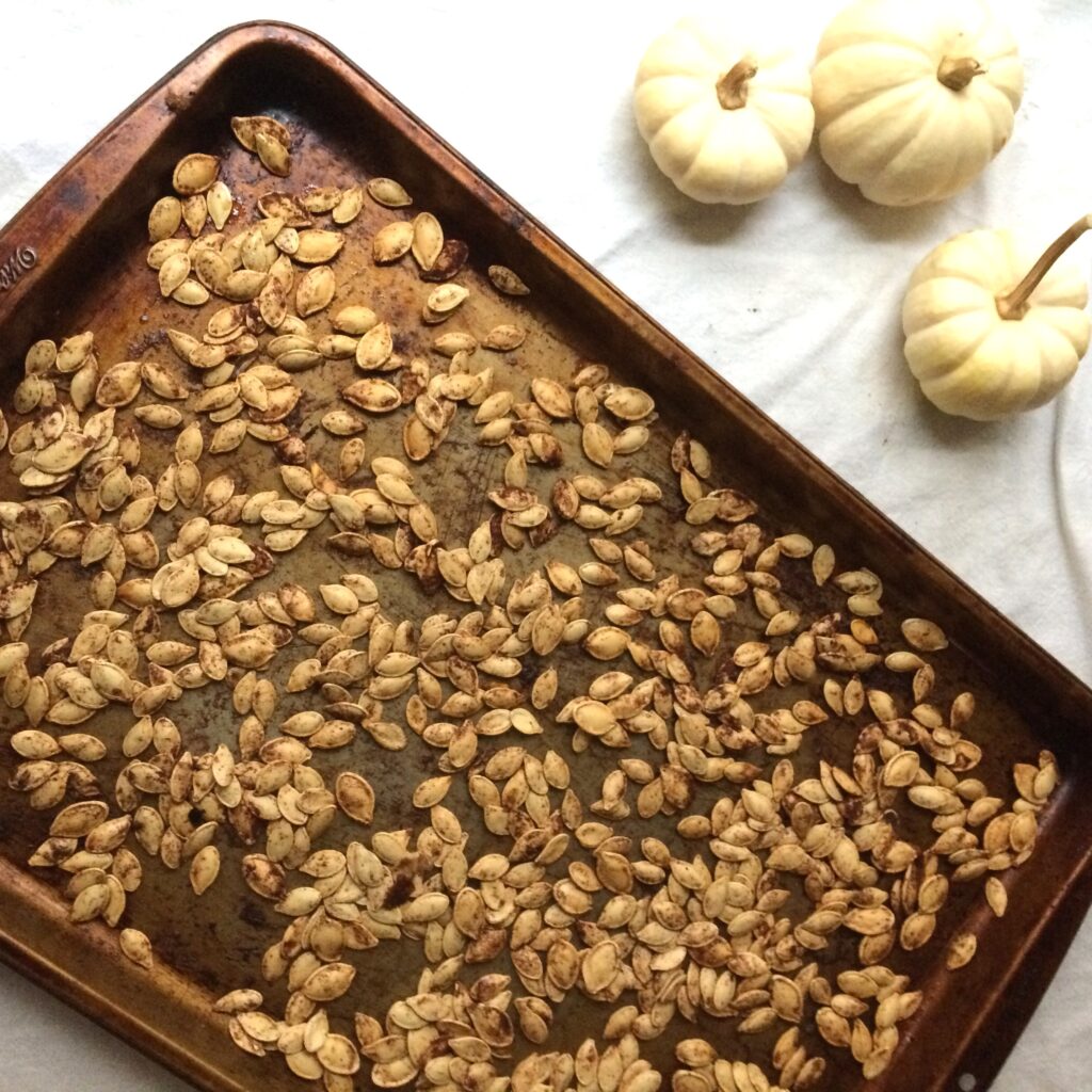 Wondering how to make roasted pumpkin seeds?  I'll show you how to cook raw pumpkin seeds into a delicious, healthy, oven-baked snack. Three easy flavour recipes to try! #pumpkin #pumpkinseeds #snack #healthy #pumpkinseeds #roasted #baked #recipe
