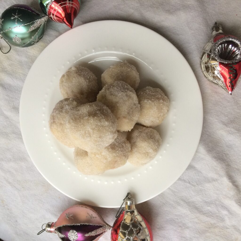 Snowballs are the perfect christmas cookie to make with your kids. A classic shortbread recipe rolled in sugar with a cherry centre? Count me in!