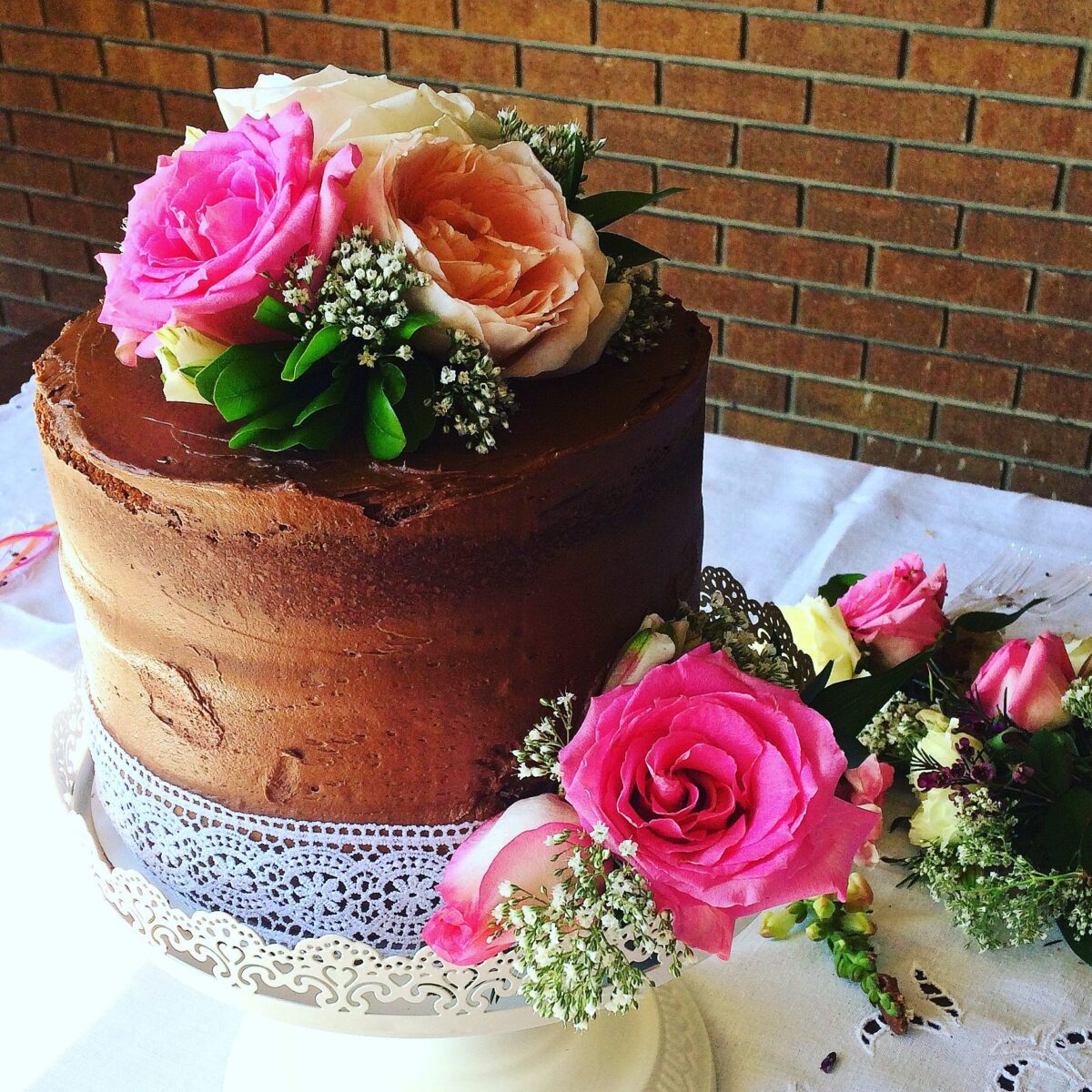 You, yes you, can easily make this gorgeous wedding cake with pink roses, carnations, and baby's breath. A DIY that will actually save you money.