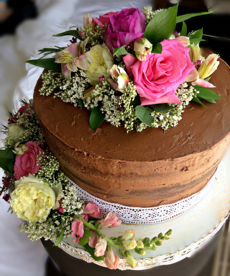 You, yes you, can easily make this gorgeous wedding cake with pink roses, carnations, and baby's breath. A DIY that will actually save you money.