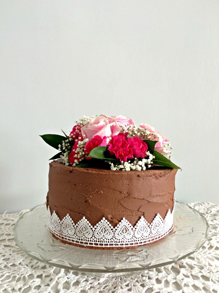 You, yes you, can easily make this gorgeous wedding cake with pink roses, carnations, and baby's breath. A DIY that will actually save you money.