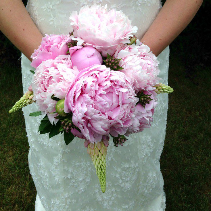 Wedding flowers for a beautiful bride using stunning pink peonies.