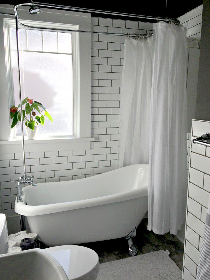 Our small bathroom renovation before and after is finally here! It's farmhouse style with lots of soothing grey and white. The best part? The pedestal sink and freestanding tub! #whitebathroom #smallbathroom #bathroomremodel #bathroombeforeandafter #whiteandgreybathroom #hexagontiles #farmhousestylebathroom #freestandingtub