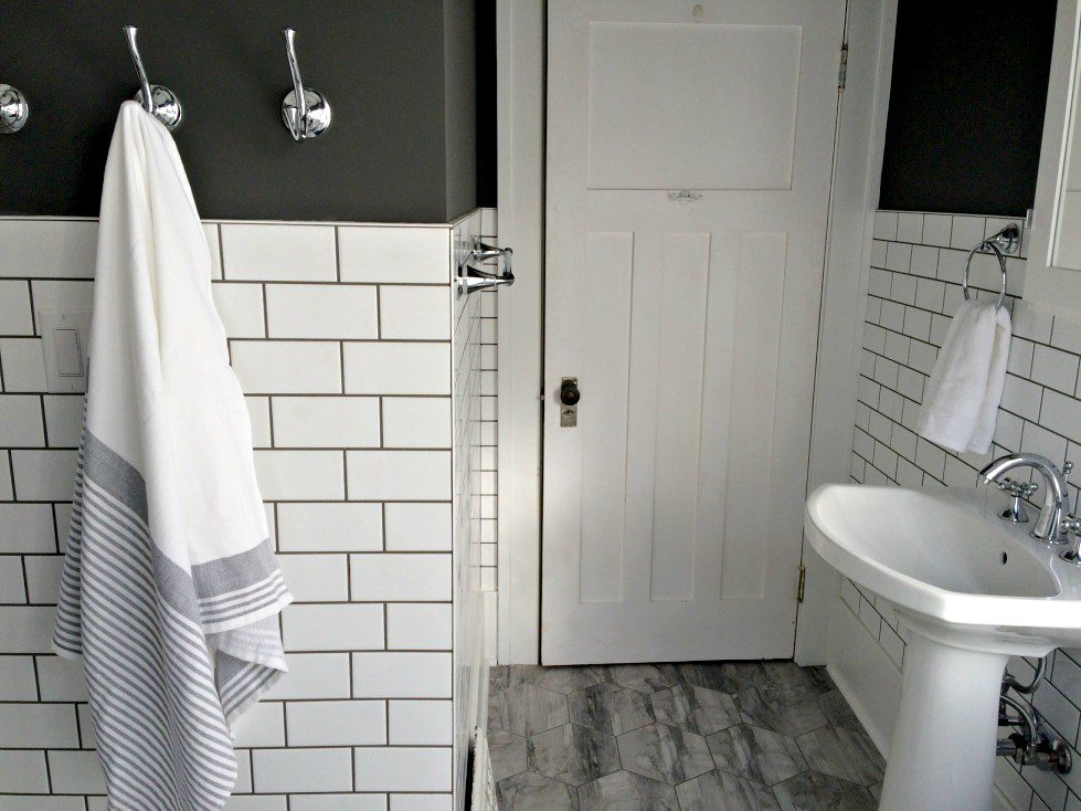 Our small bathroom renovation before and after is finally here! It's farmhouse style with lots of soothing grey and white. The best part? The pedestal sink and freestanding tub! #whitebathroom #smallbathroom #bathroomremodel #bathroombeforeandafter #whiteandgreybathroom #hexagontiles #farmhousestylebathroom #freestandingtub