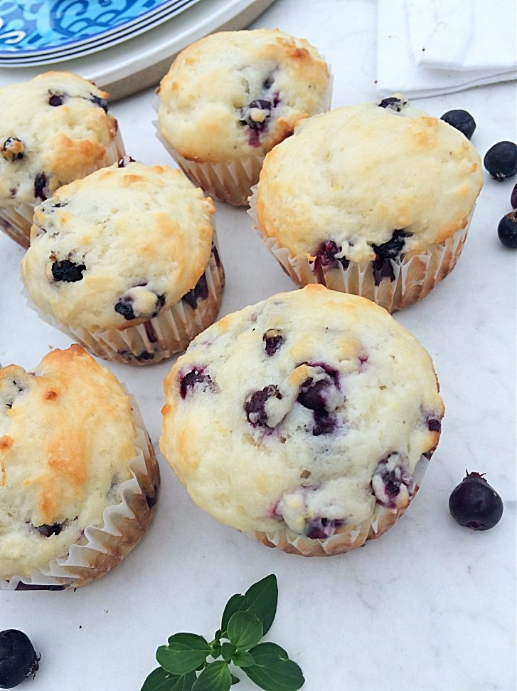 Saskatoon berry muffins make for a healthy after school snack. You'll love this easy dessert recipe with hints of lemon. Substitute blueberries if you can't find Saskatoon berries. #muffinrecipes #saskatoonberries #afterschoolsnacks #healthysnacks #blueberries