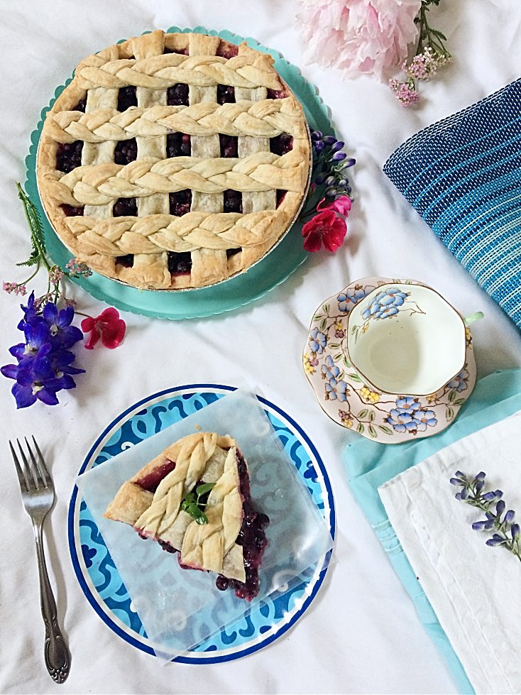 It just isn't summer without a slice of Saskatoon berry pie! This easy dessert recipe has a traditional crust, loads of saskatoon berries (or blueberries) filling, and just a hint of lemon. #saskatoonberries #pie #pierecipe #easydessert #summerdessert #berryrecipe #hardyfruits