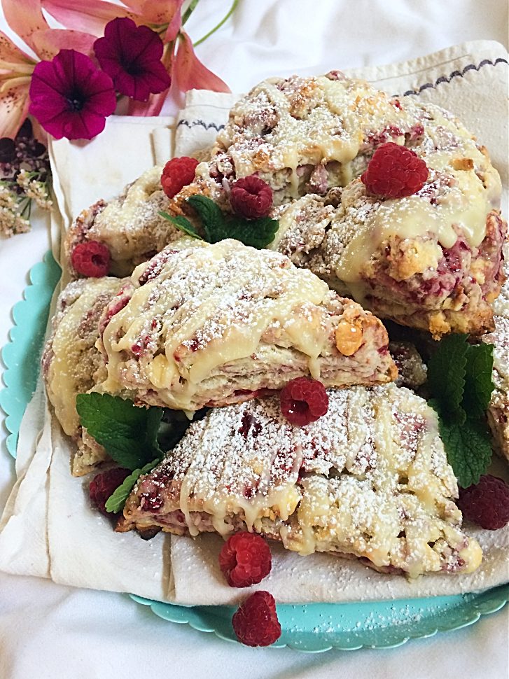 Seriously, you need these raspberry white chocolate scones in your life.  They're an easy and simple summer dessert recipe that is perfect for breakfast, dessert, or as a snack. #raspberry #whitechocolate #scone #sconerecipe #dessert #baking 