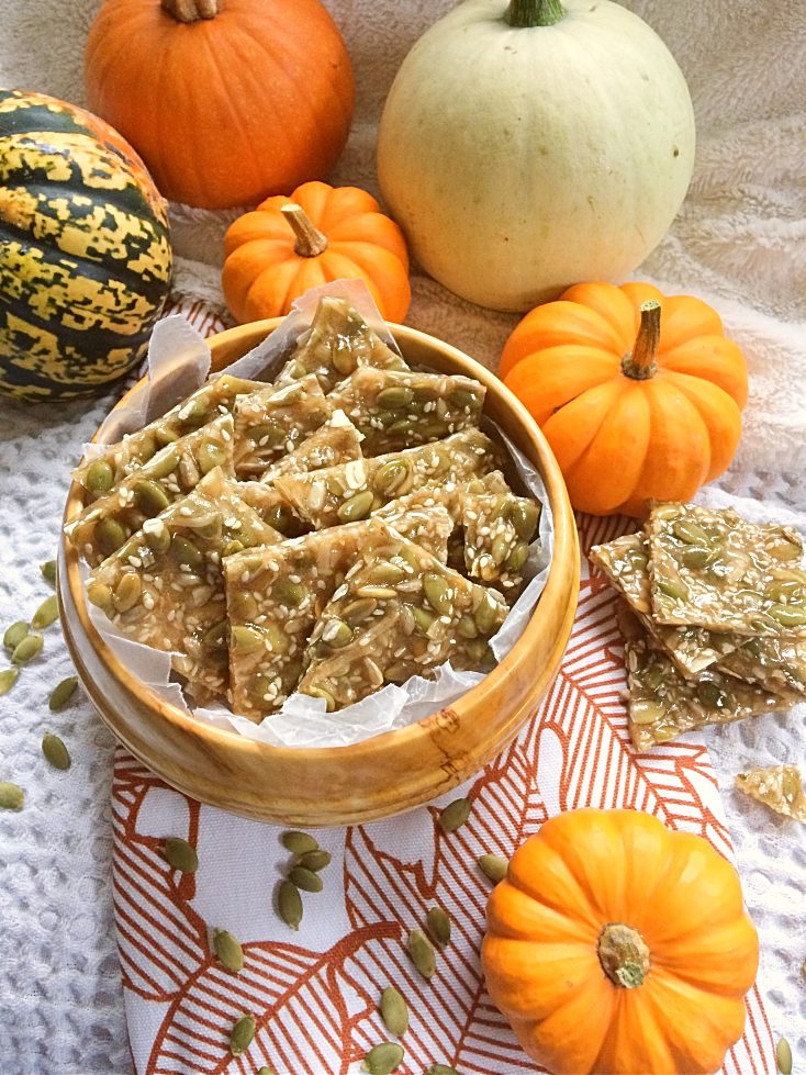 Spiced pumpkin seed brittle is a fun fall twist on classic peanut brittle. It's an easy dessert recipe that you can make for homemade gifts, cookie exchanges, Christmas baking, Thanksgiving, and more! #pumpkinseed #peanutbrittle #Thanksgiving #pumpkinrecipes #fallrecipes #dessert #sweettreats #cookieexchange