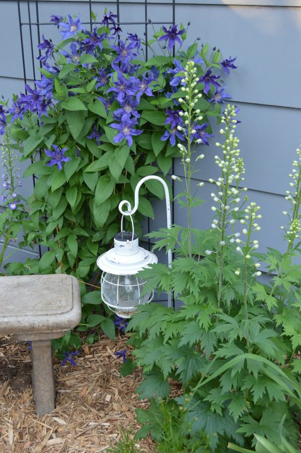 I think whimsical garden art really makes a backyard flower bed.  I love these 20 diy ideas that are either recylcled, upcylcled, or from junk that nobody wants.  I need to do some of these in my outdoor space--I could get this shepherds hook for cheap at the dollar store. #gardenart #whimsical #flowergarden #landscapingideas