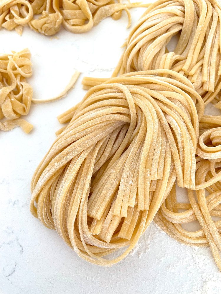 homemade noodles on a white marble countertop
