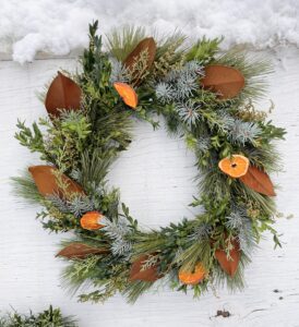 evergreen wreath with magnolia and oranges