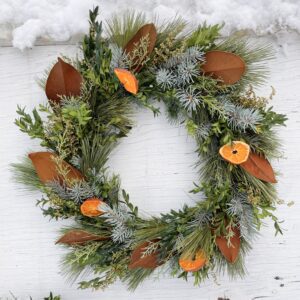 evergreen wreath with magnolia and oranges