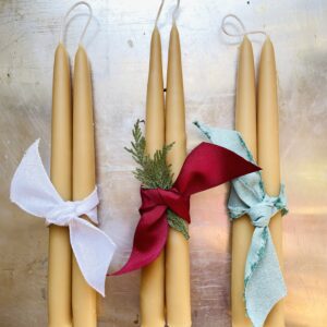 3 sets of hand-dipped beeswax candles tied together with ribbon